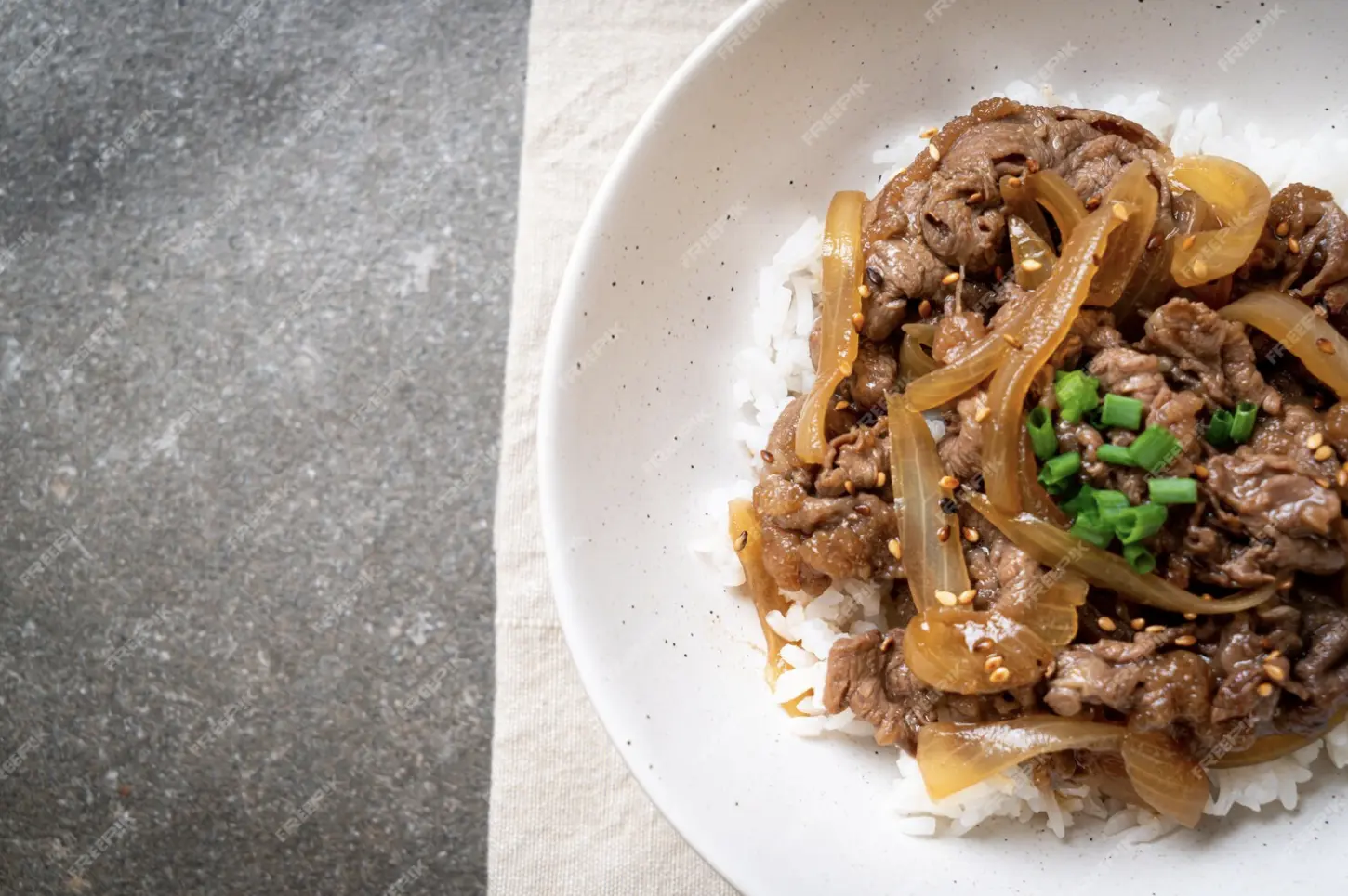 Ground Beef Bulgogi served with rice and garnished with sesame seeds and green onions.